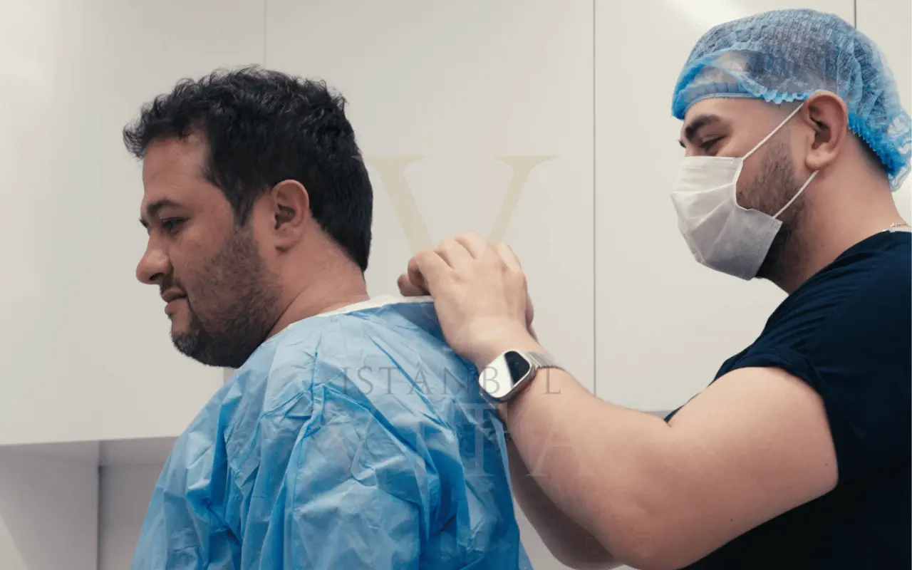 doctor is helping patient to get ready for the hair transplant