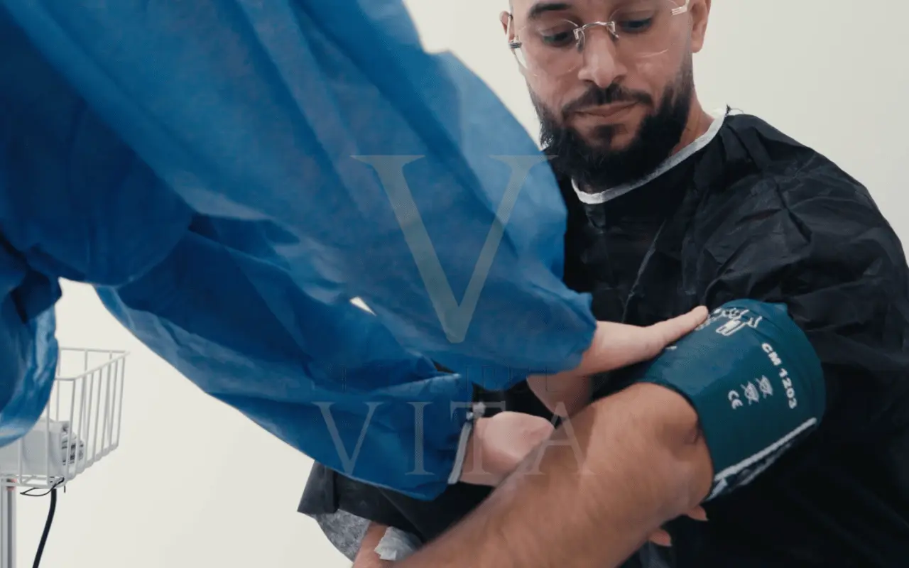 dr is checking bp before hair transplant procedure