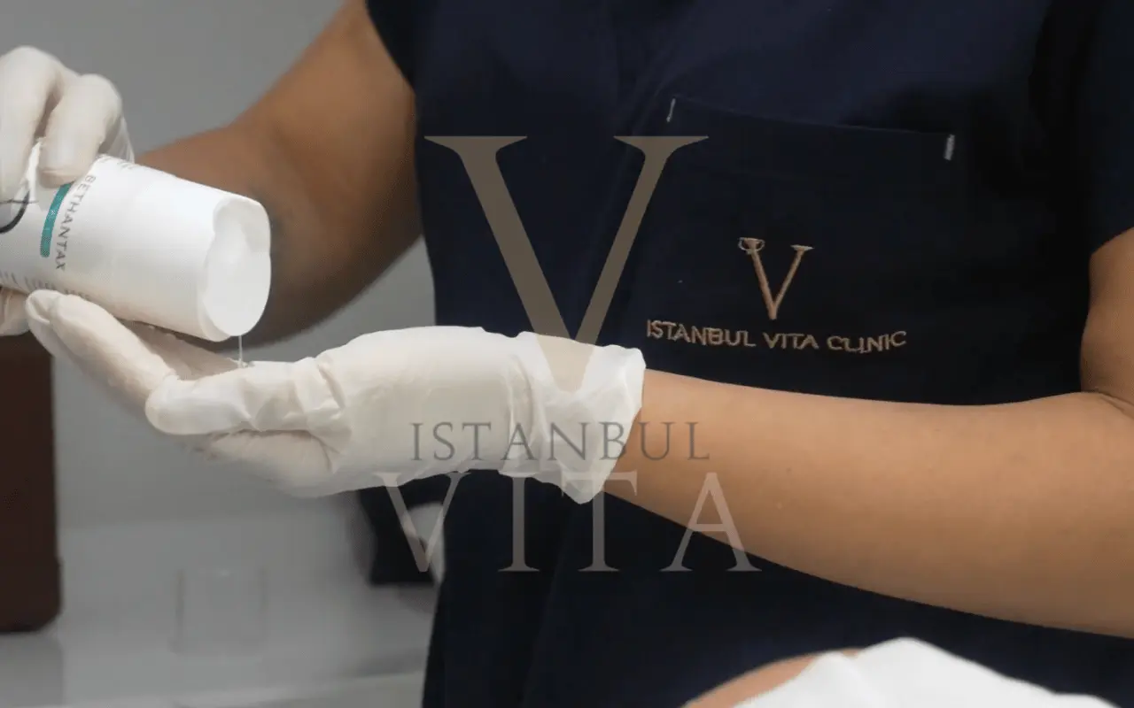 dr is holding shampo that is used for hair transplant patients